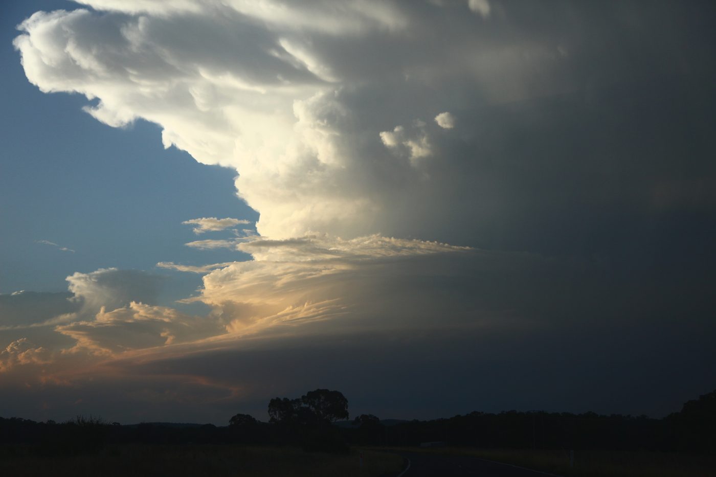 A shaded supercell updraft with sunlit tops