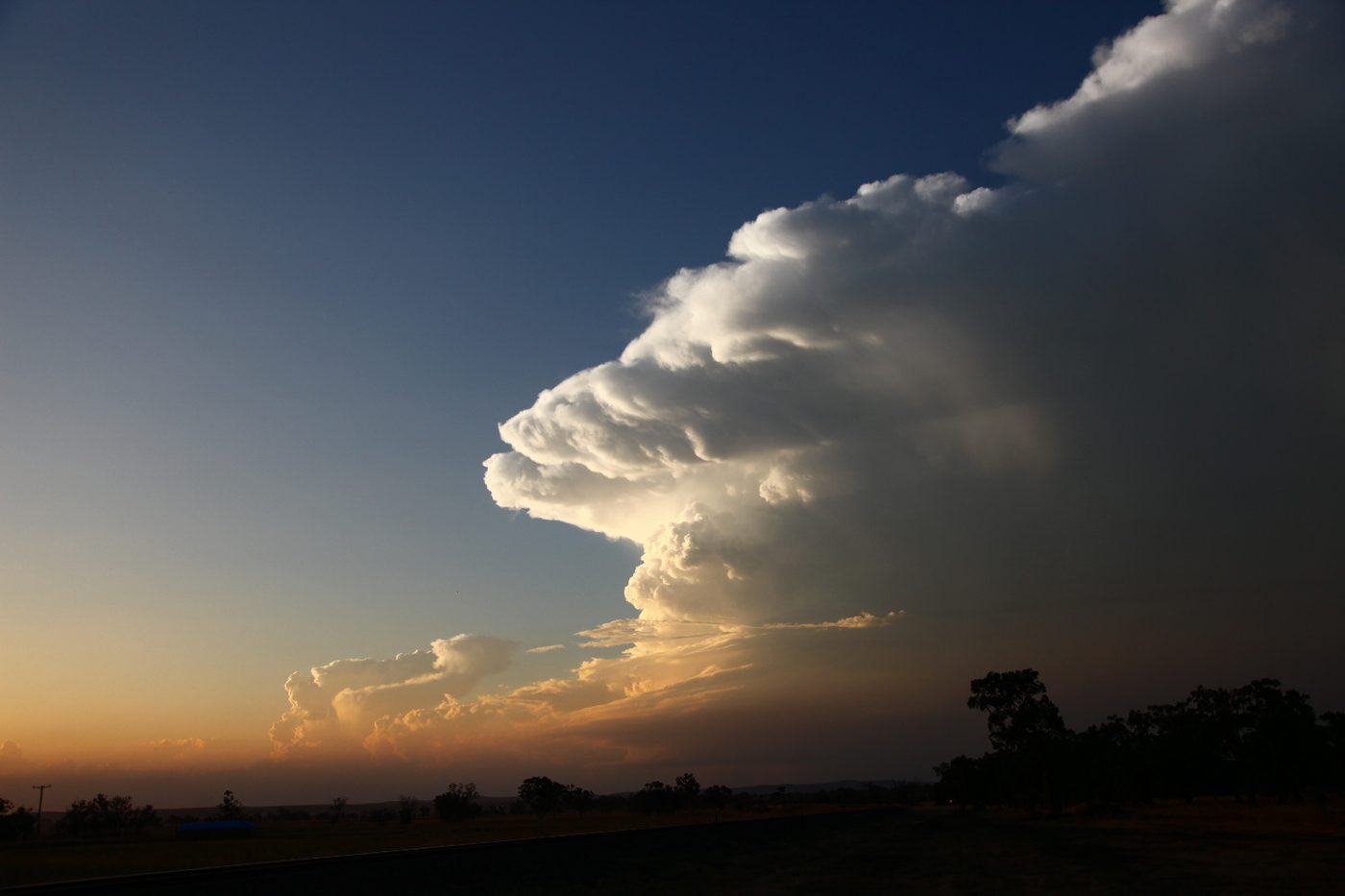 A bright white towering supercell cloud against deep blue sky